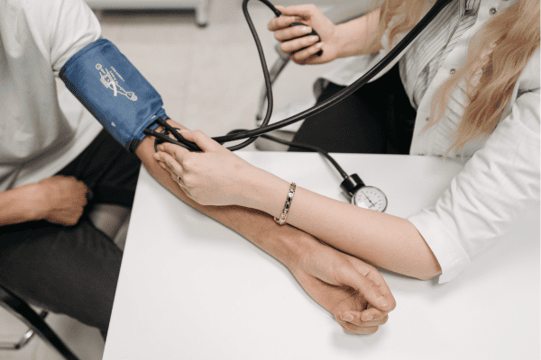 a lady Doctor check blood pressure of the patient