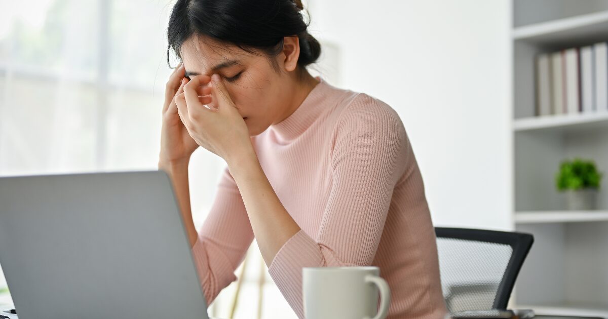 a female headache due to work on laptop