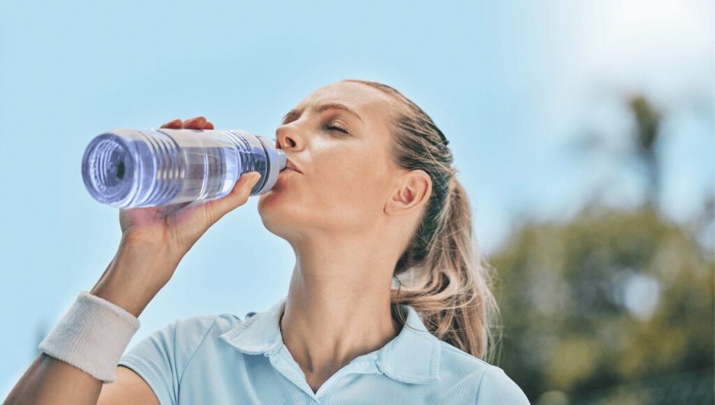 a women drink water in summer